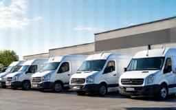 Fleet of clean vans outside warehouse